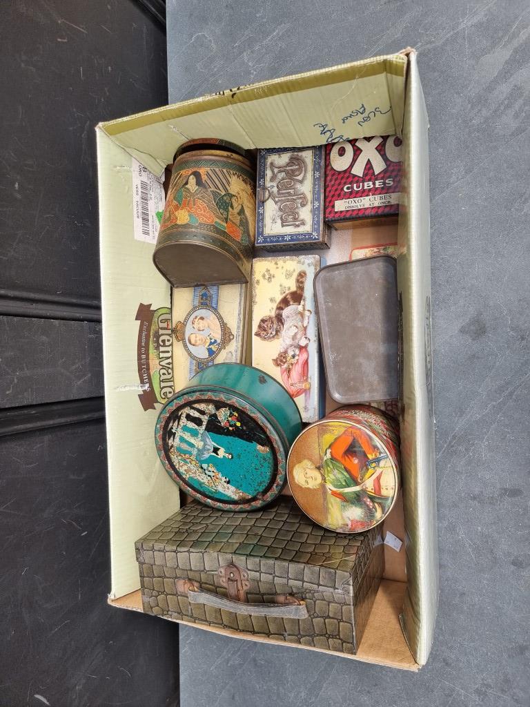 A collection of old tins, to include a simulated crocodile example.