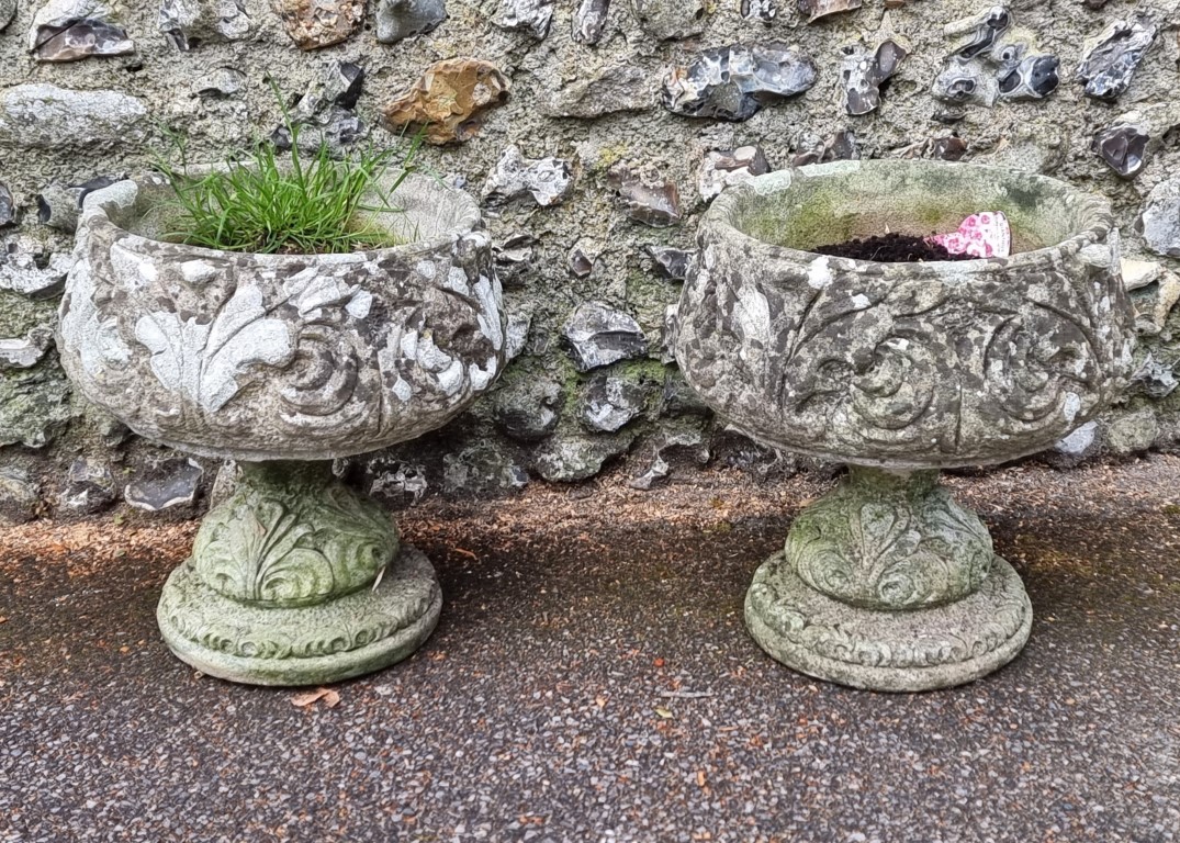 An old pair of weathered composition stone garden pots, 47cm high; together with another pedestal