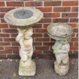 A composition stone figural sun dial, 98m high; together with a similar small bird bath. (2)