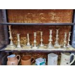 A group of antique brass candlesticks, largest 20cm high. (9)