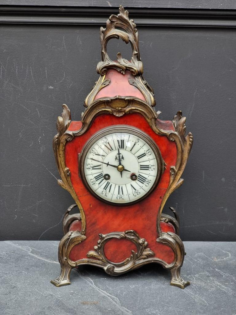 A Louis XV style tortoiseshell mantel clock, 39.5cm high, with pendulum.