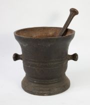 A cast iron pestle and mortar