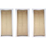 A set of three unusual curved wooden doors and surrounds