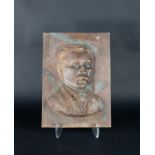 A bronze portrait plaque