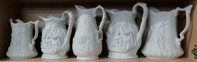 Five Parian ware jugs, various sizes