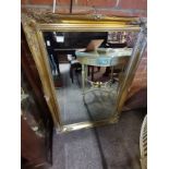 A large reproduction gilt framed mirror