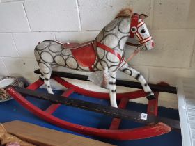 A child's wooden and papier-mâché rocking horse, dapple grey