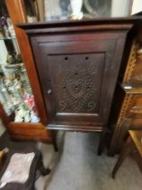 An early oak Cheese cupboard with decoration dating