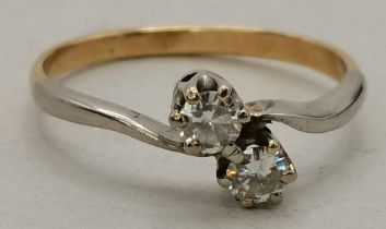 An 18 carat gold and white gold diamond cross-over ring