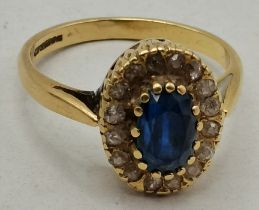 An 18 carat gold sapphire and diamond cluster ring