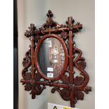 A hardwood carved mirror