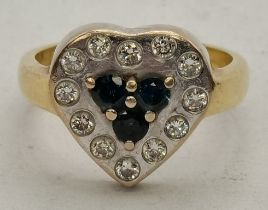 An Art Deco 18 carat white and yellow gold heart-shaped diamond and sapphire ring