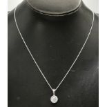 An 18 carat white gold solitaire pendant necklace