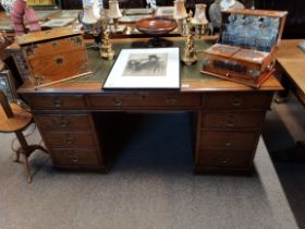 An Antique oak pedestal desk with makers plaque