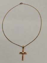 An 18 carat gold and red stone crucifix