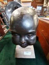 A full life size bronze bust of a baby on granite plinth