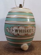 A large ceramic 'WHISKEY' barrel, converted to a table lamp