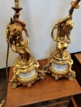 A good pair of gilt and onyx table lamps with cherub decoration 40cm
