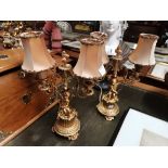 A pair of gilt table lamps with cherub decoration 35cm high