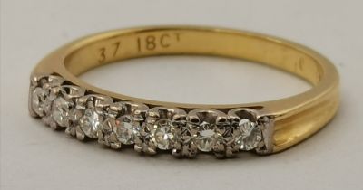 An 18 carat gold half hoop seven-stone ring