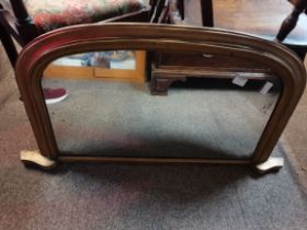 An arched overmantel mirror with gilt frame