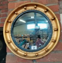 A Regency-style gilt convex mirror