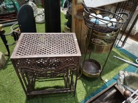 Cast iron next of tables, umbrella stand and bowl with decorative eggs
