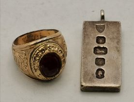 An Elizabeth II silver ingot pendant, and a gold-plated US Navy ring