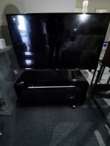 LG flatscreen TV with black glass stand and Sony DVD player