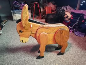 A plank carved wooden model of a donkey
