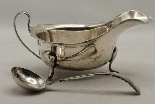 A 20th Century silver sauceboat and ladle