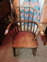 A Childs Windsor chair in elm