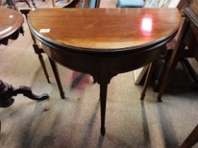 A mahogany Antique card table with tapered legs