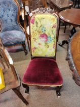 A Victorian rosewood/walnut nursing chair