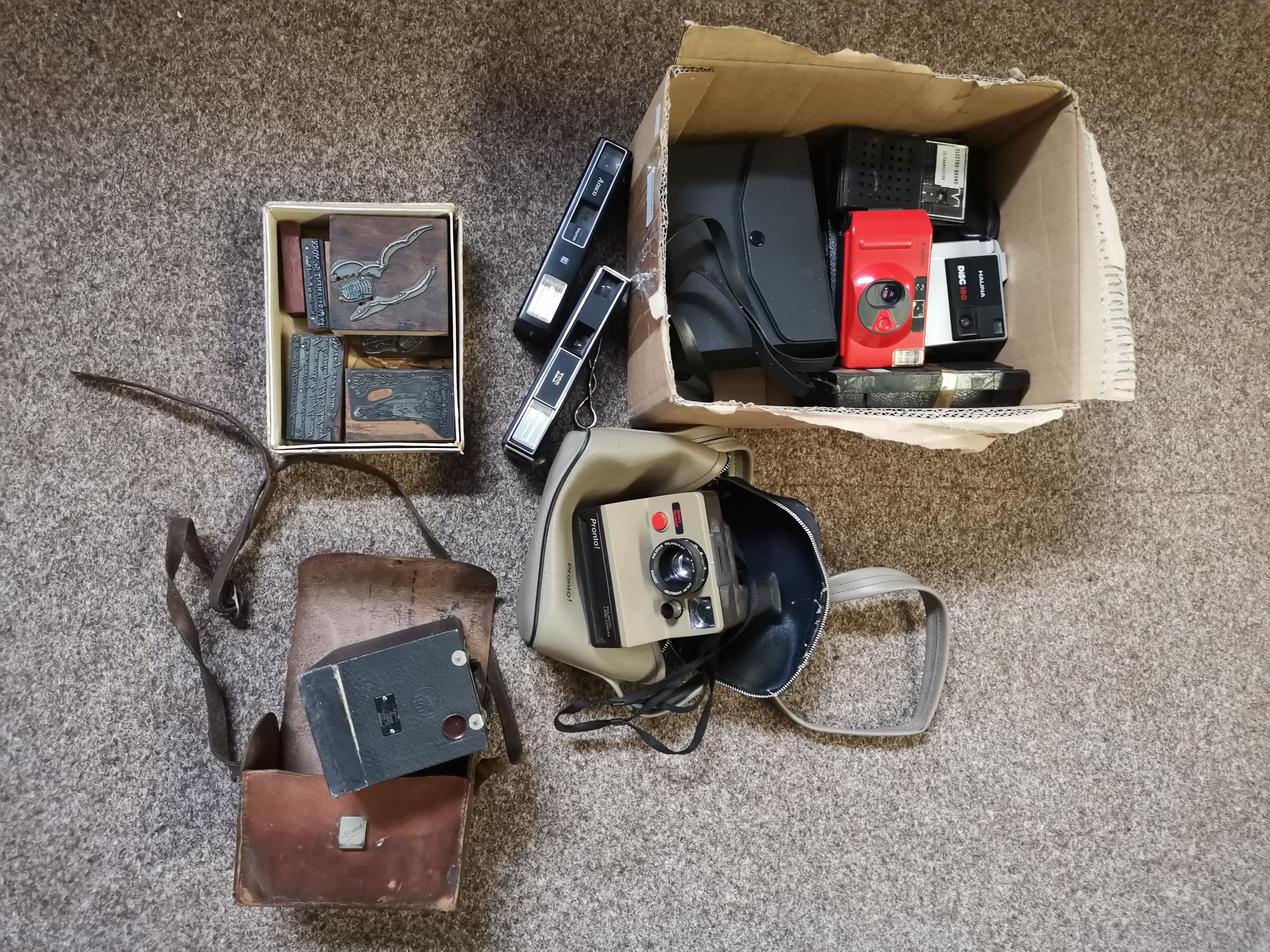 A mixed collection of old cameras and radios, etc.