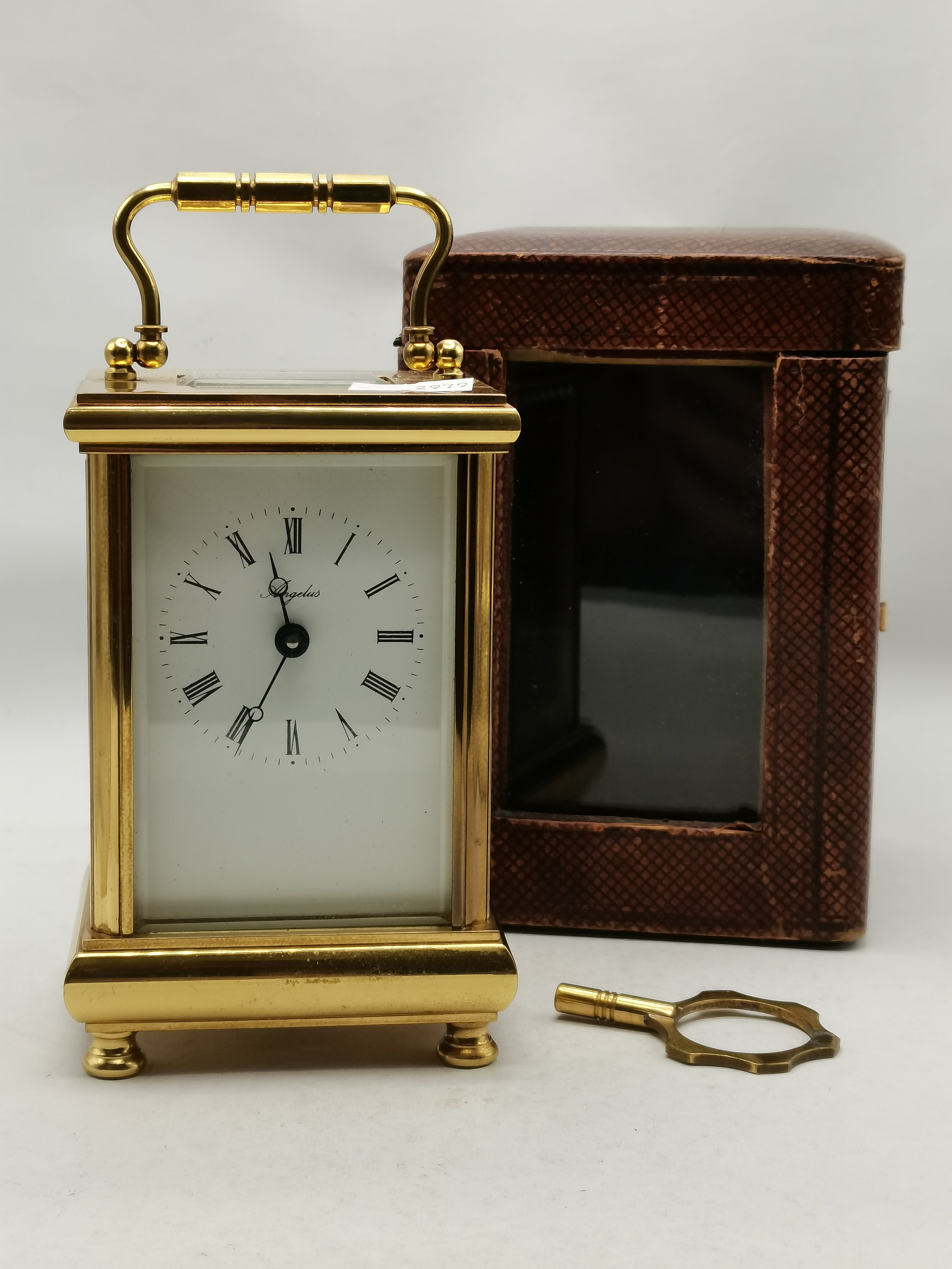 An English brass carriage clock with leather travel case, 20th Century