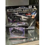 K2 A SEGA Mega Drive 16-BIT games console and Mega Stick, 1980's factory sealed each boxed. (2)