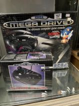 K2 A SEGA Mega Drive 16-BIT games console and Mega Stick, 1980's factory sealed each boxed. (2)