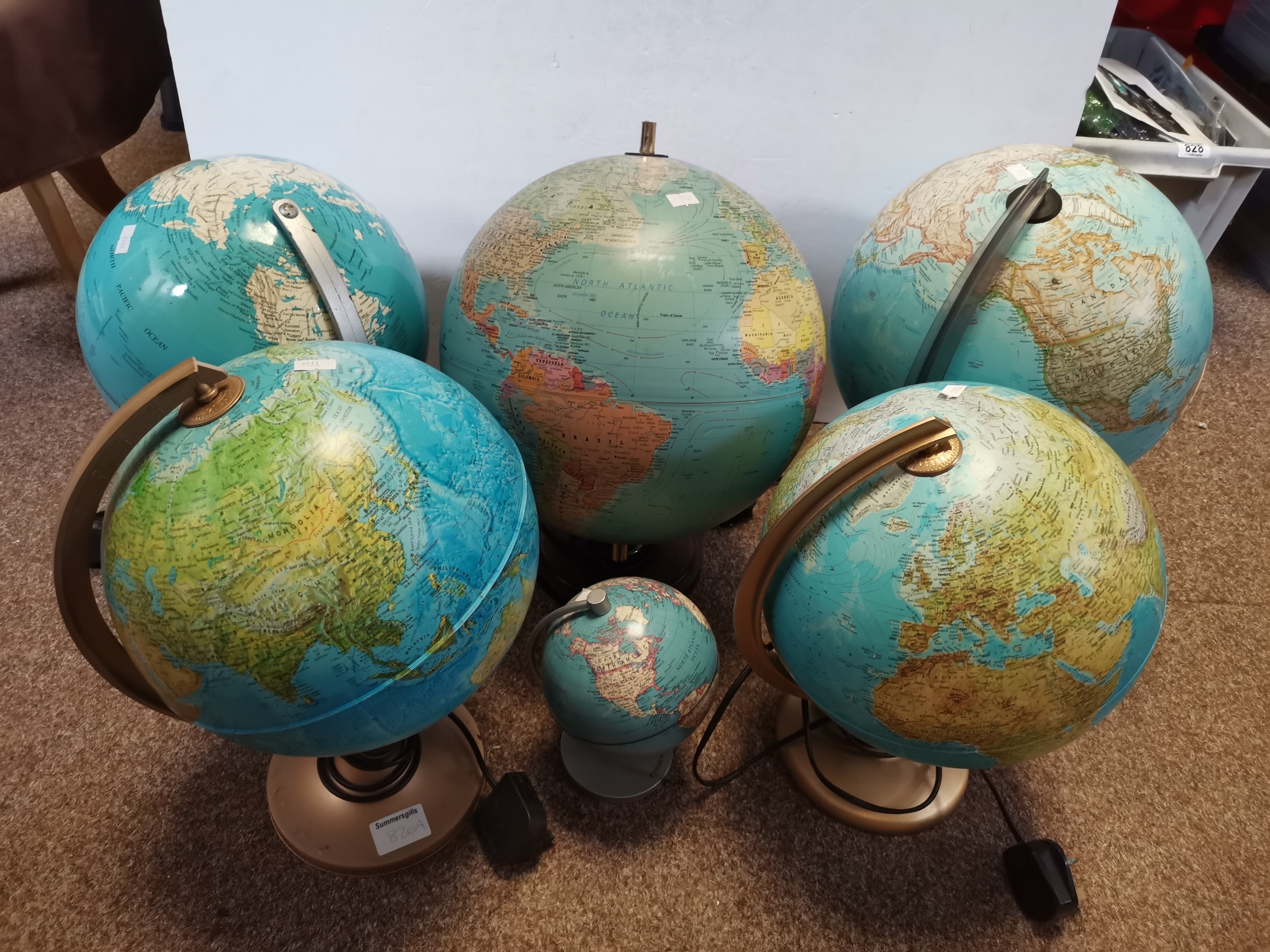 Six modern globes on stands