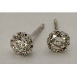 A pair of 9 carat white gold solitaire diamond stud earrings