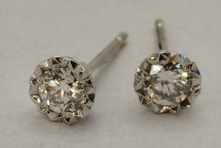 A pair of 9 carat white gold solitaire diamond stud earrings