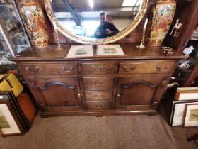 A Reproduction Oak Dresser with 6 drawers and two cupboards