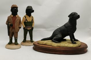 A Border Fine Arts figure of a black labrador dog, seated