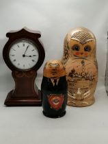 An Edwardian mahogany inlaid mantel clock, and two Russian dolls