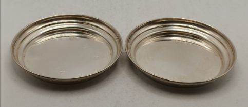 A pair of Elizabeth II silver bottle coasters