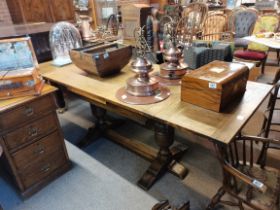 An oak draw leaf dining table with bulbous supports