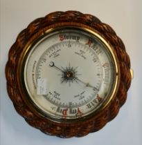 An oak-mounted aneroid barometer