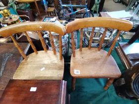 A pair of antique wooden children's chairs
