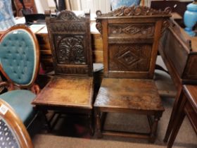 2 x early oak hall/ church chairs with carved deco