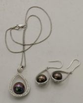 An 18 carat white gold diamond and black pearl necklace and earring suite